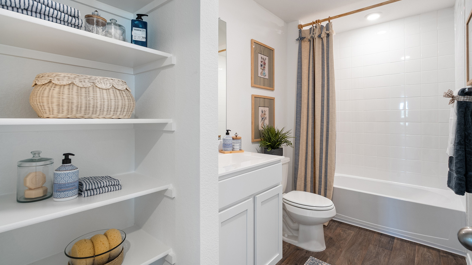 Bathroom with white shelving and a shower with a bathtub