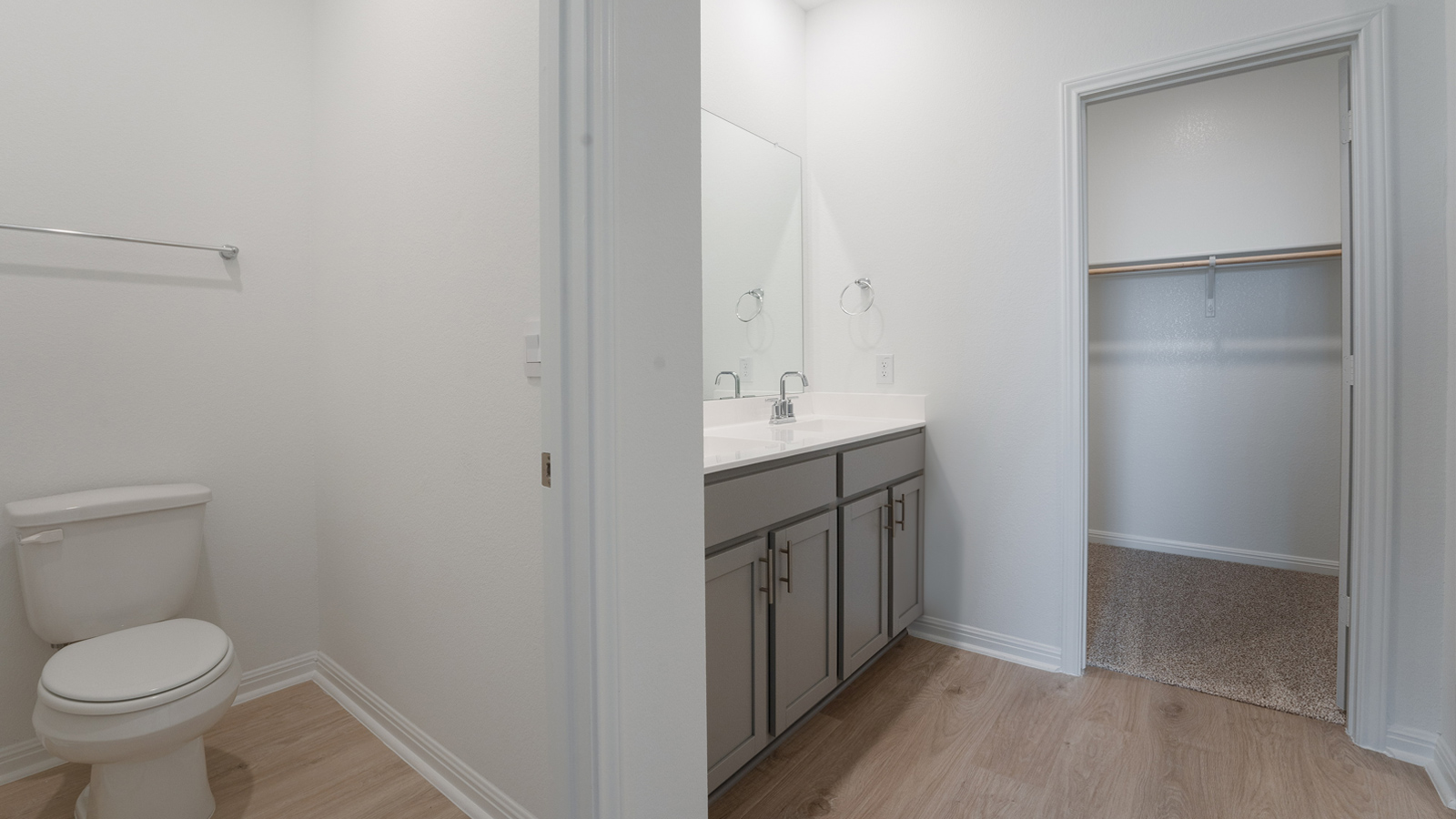 Main bathroom includes separate room for toilet and double vanity sink.