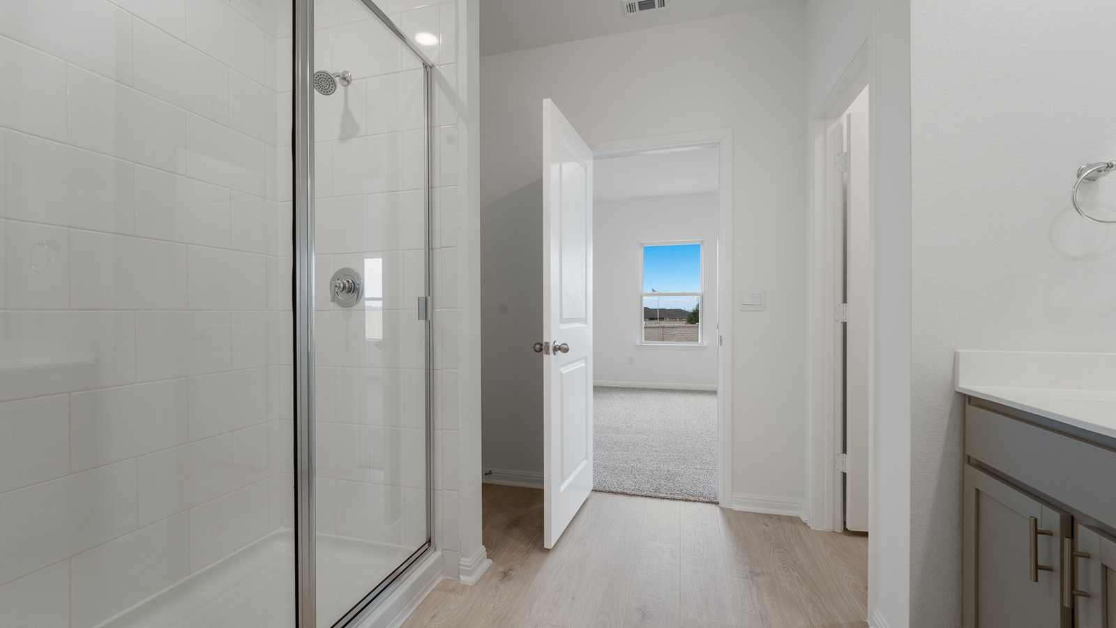 Walk-in shower with tiled walls.