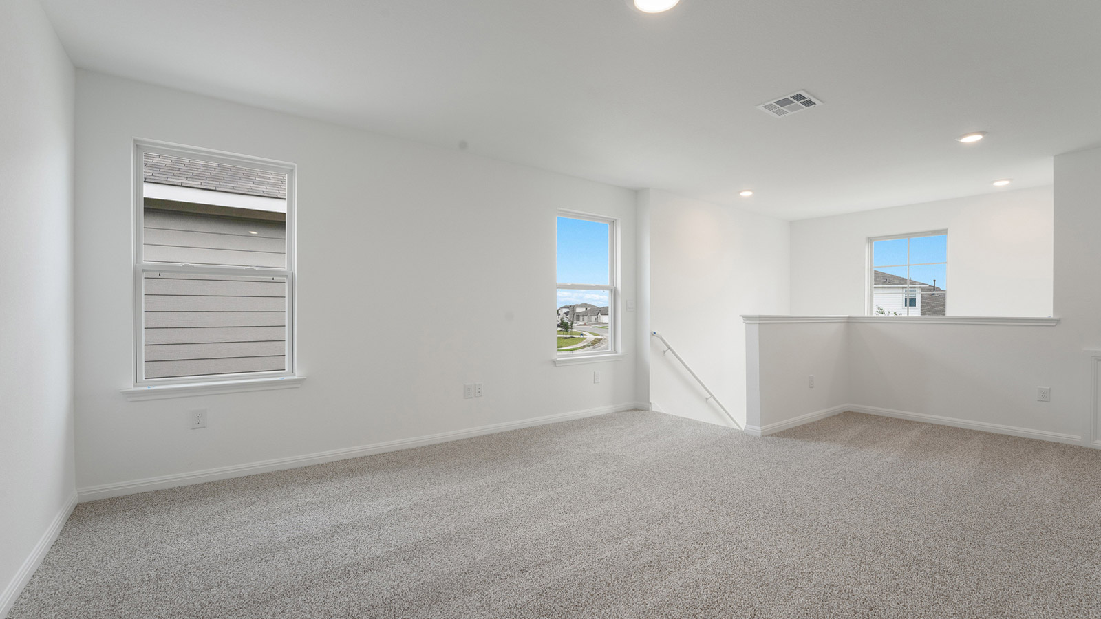 Upstairs loft with carpeted floors.