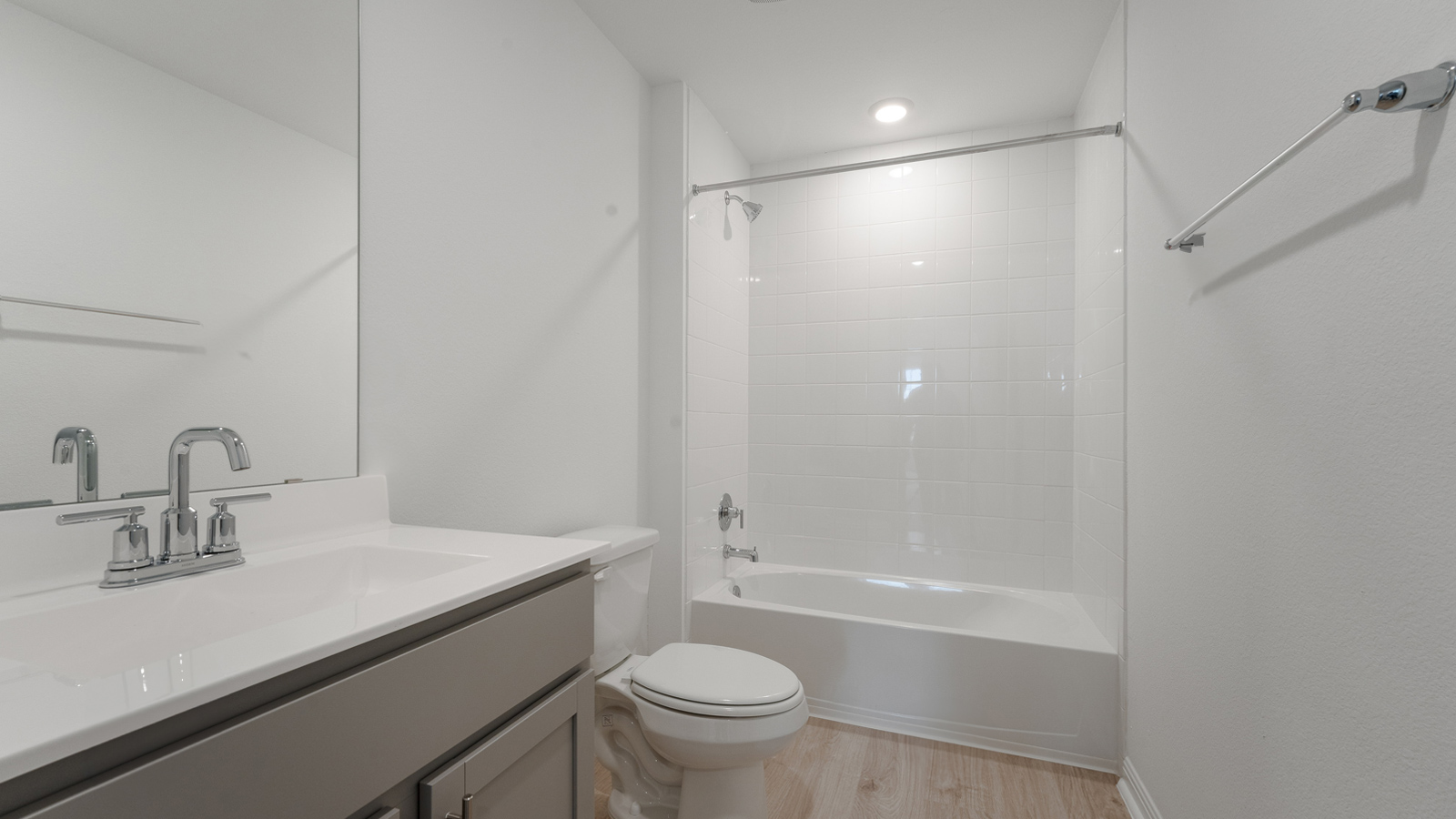 Bathroom 2 with single vanity sink, toilet, bathtub, and shower.