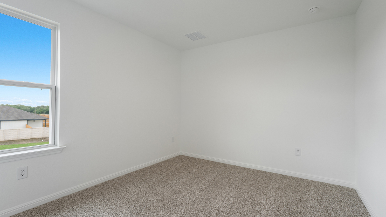 Bedroom 2 with carpeted floors and windows.