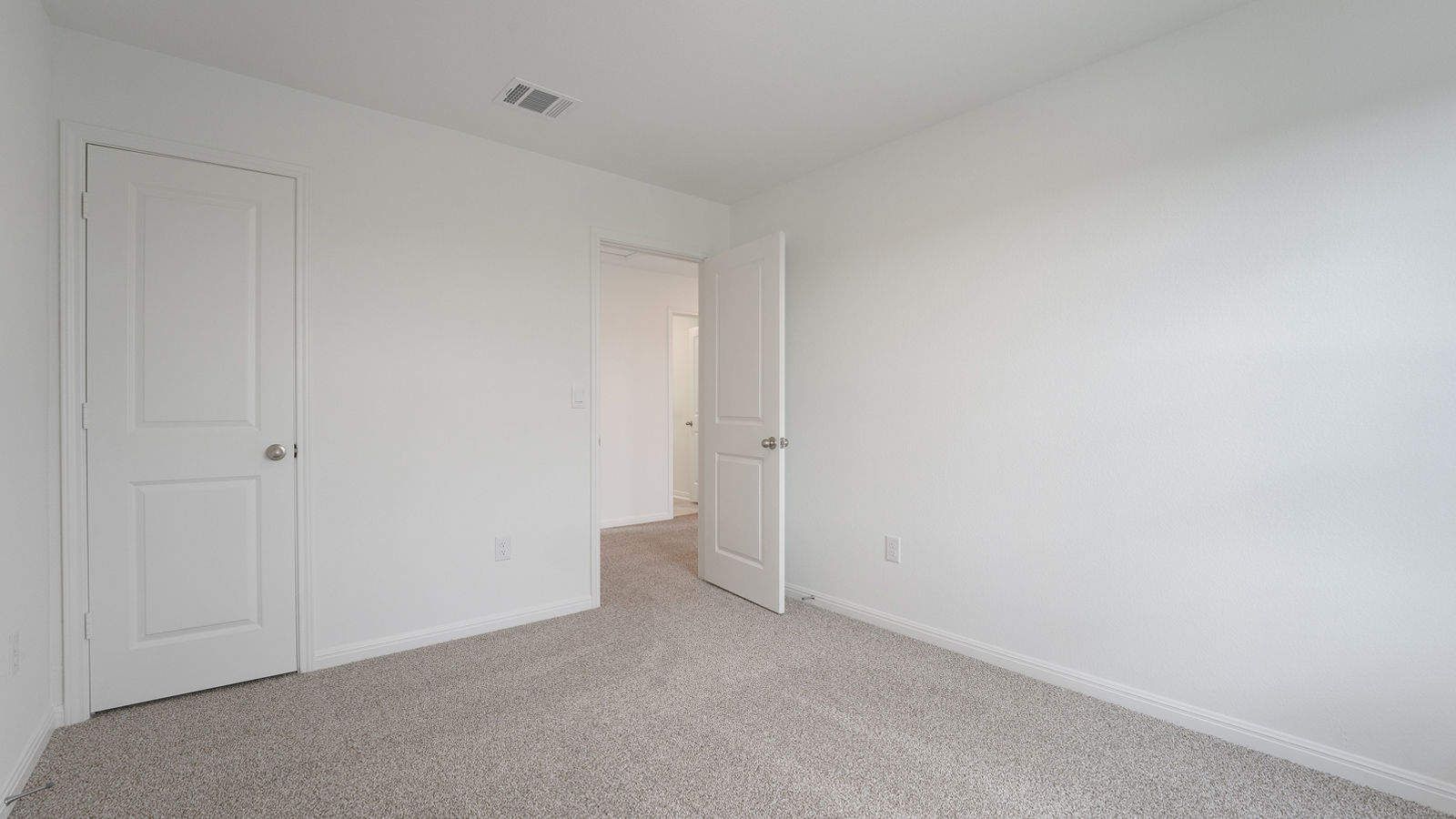 Bedroom 3 with carpeted floors and windows.