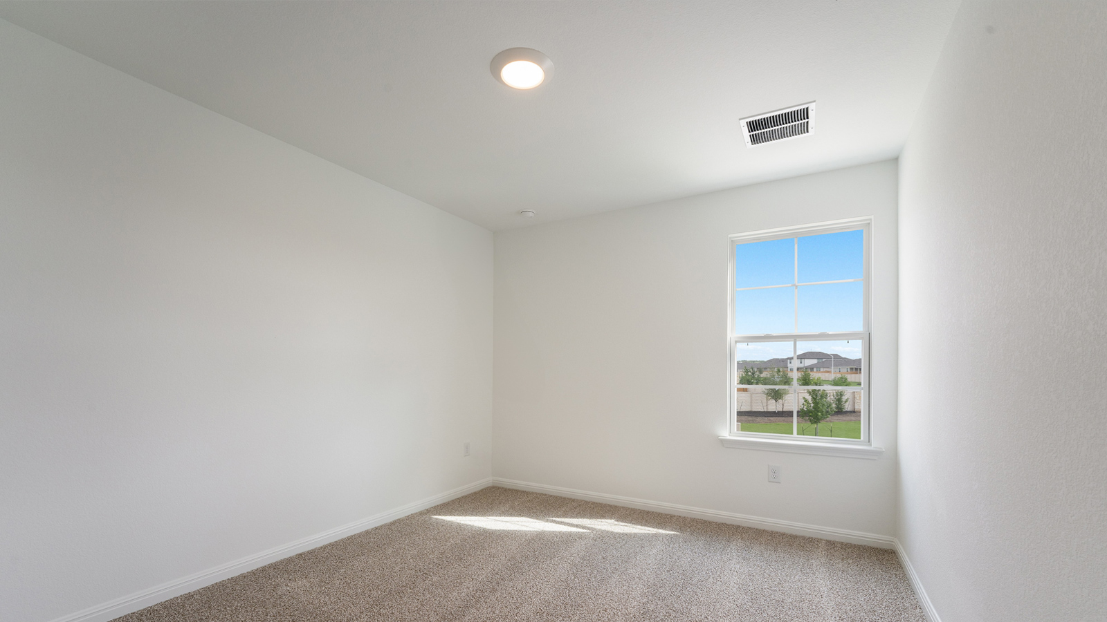 Bedroom 4 with carpeted floors and windows.