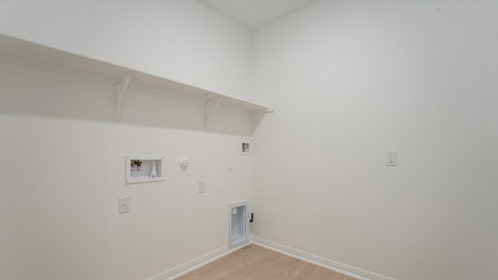 Utility room with washer and dryer connection.