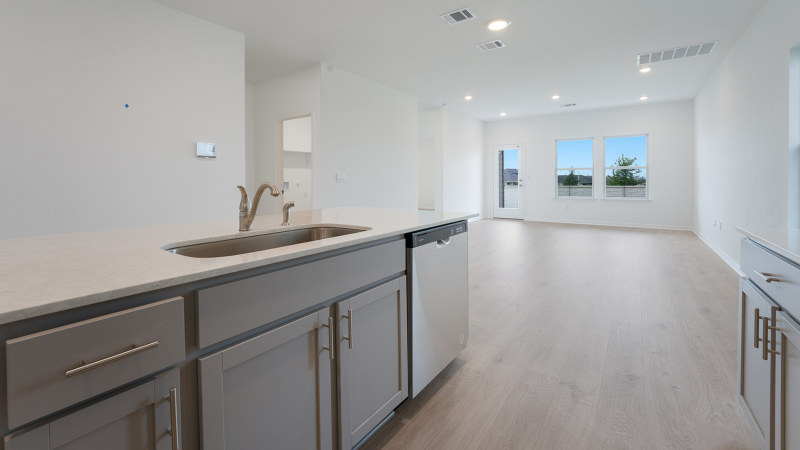 Large kitchen island with single undermount sink.