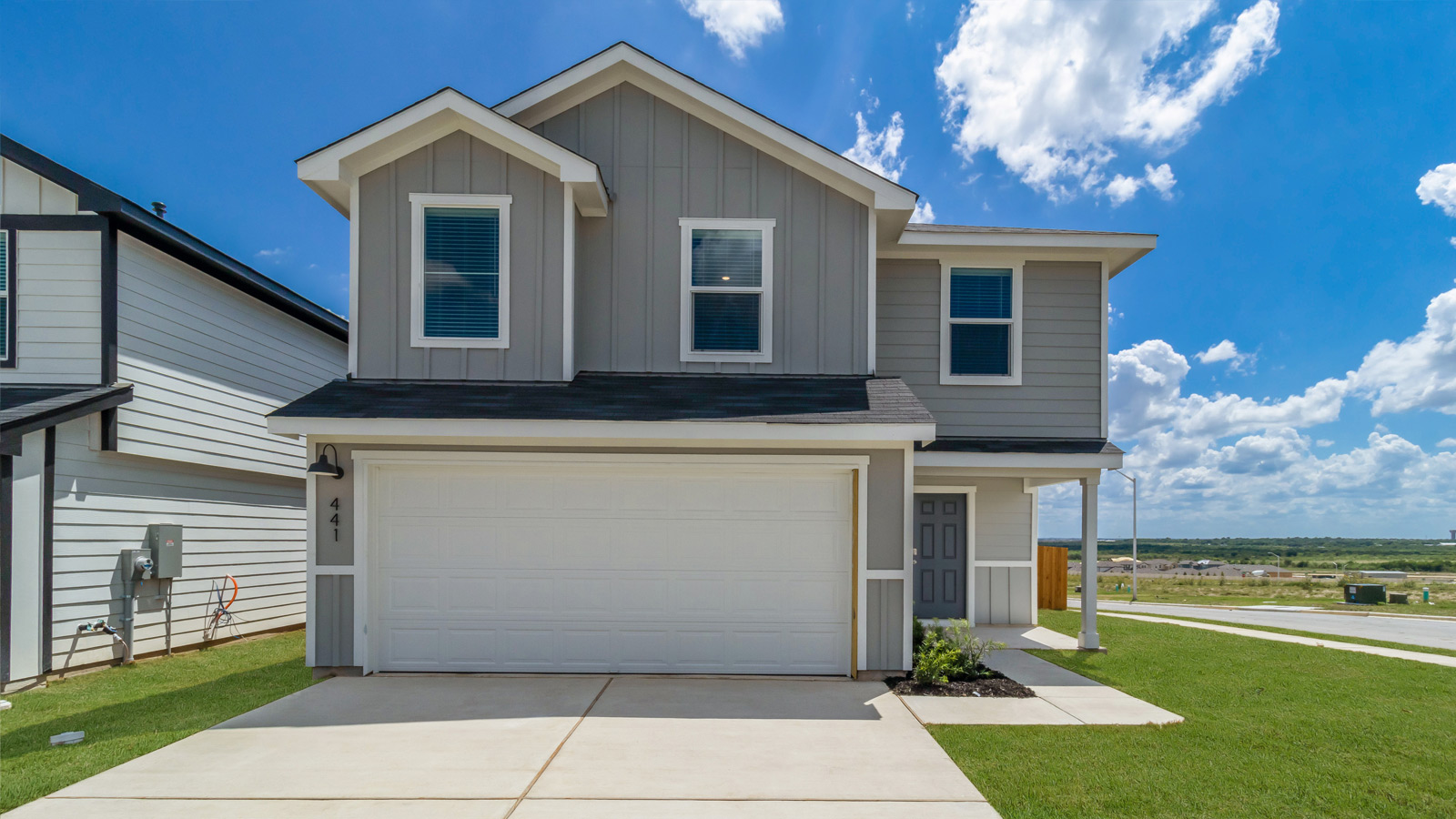 Two story new build home with neutral exterior and a two car garage.