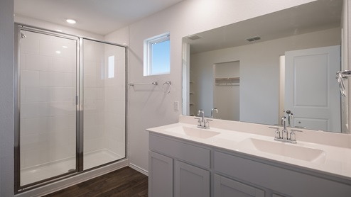main bathroom with double vanity and walk-in shower
