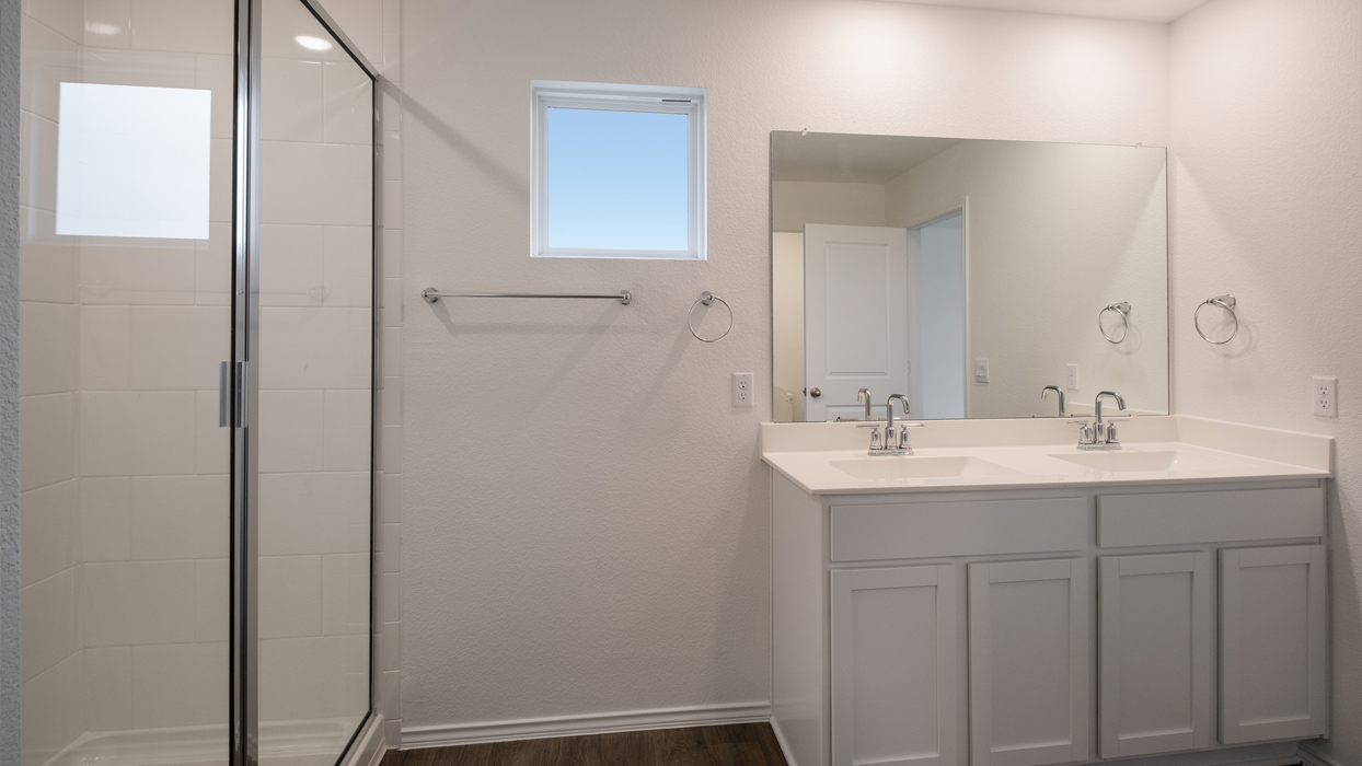main bathroom with double vanity and walk-in shower