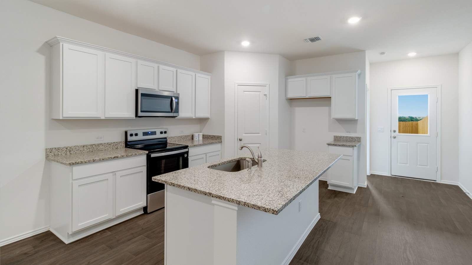 kitchen with white cabinetry, large island and stainless steel appliances