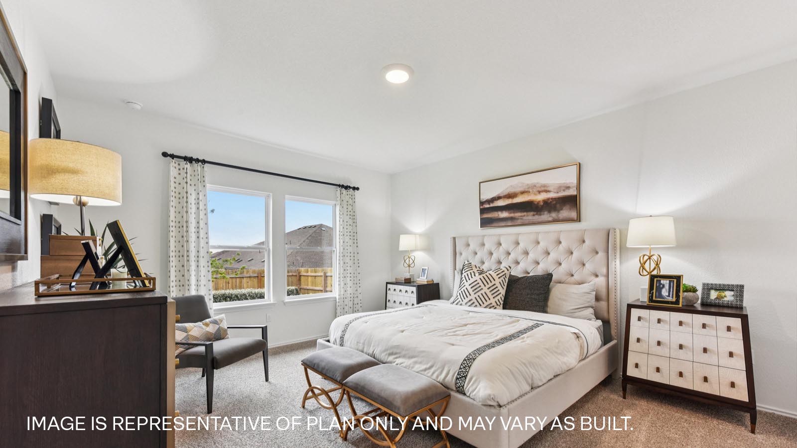 Main bedroom with carpeted flooring and windows.