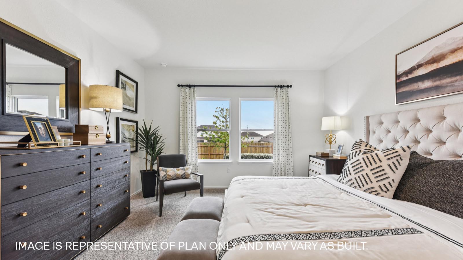 Main bedroom with carpeted flooring and large windows.