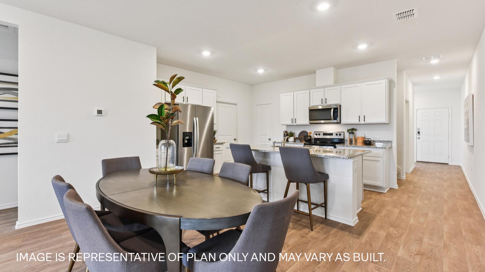 Open living area with vinyl flooring and windows overlooking backyard.