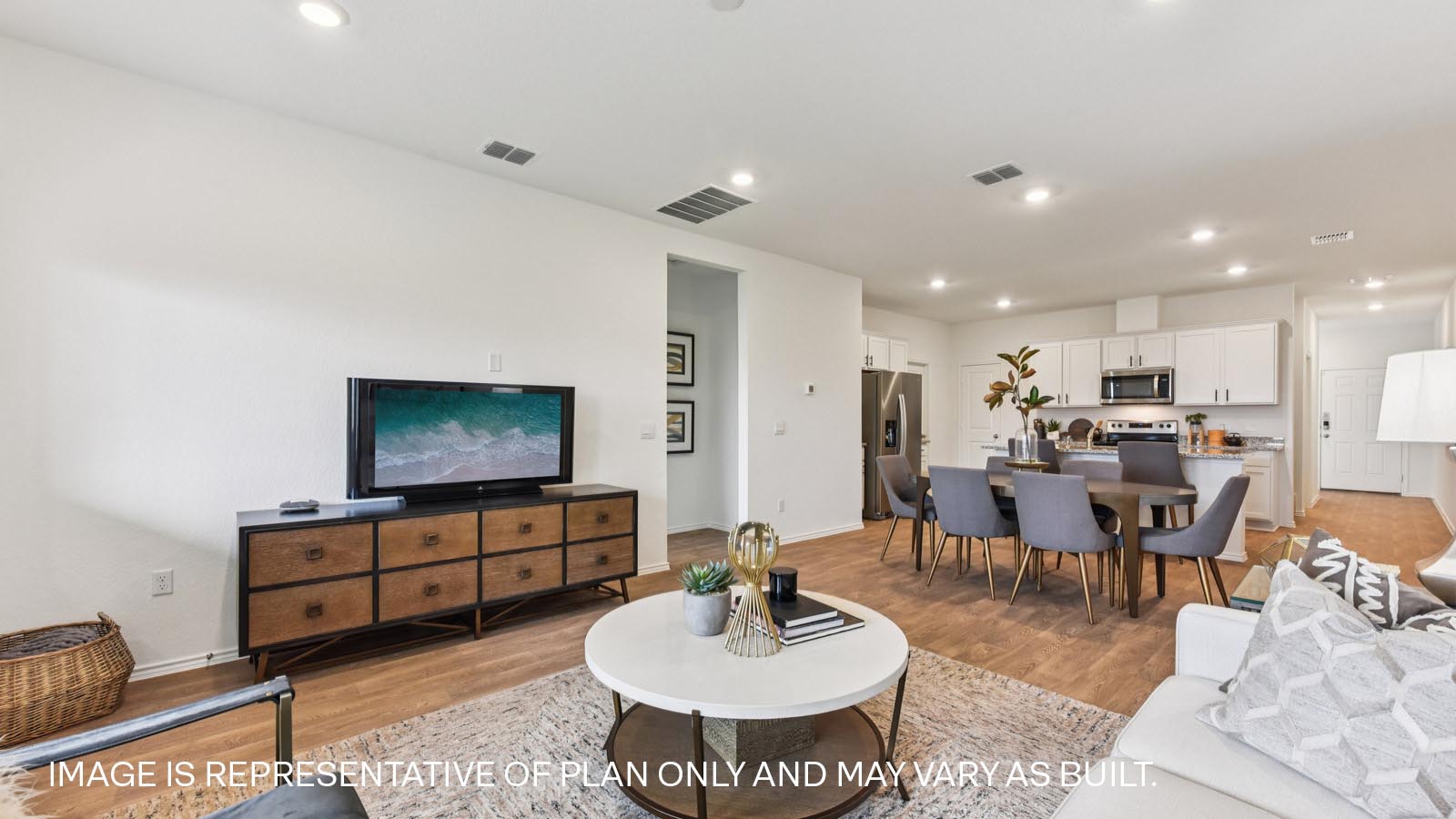 Open living area with vinyl flooring and windows overlooking backyard.