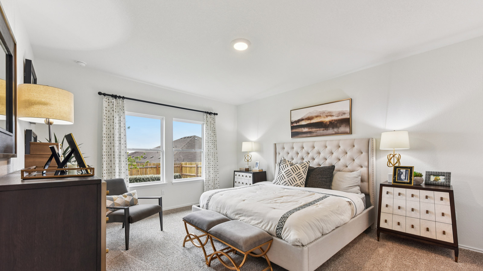 Main bedroom with carpeted flooring and large windows.