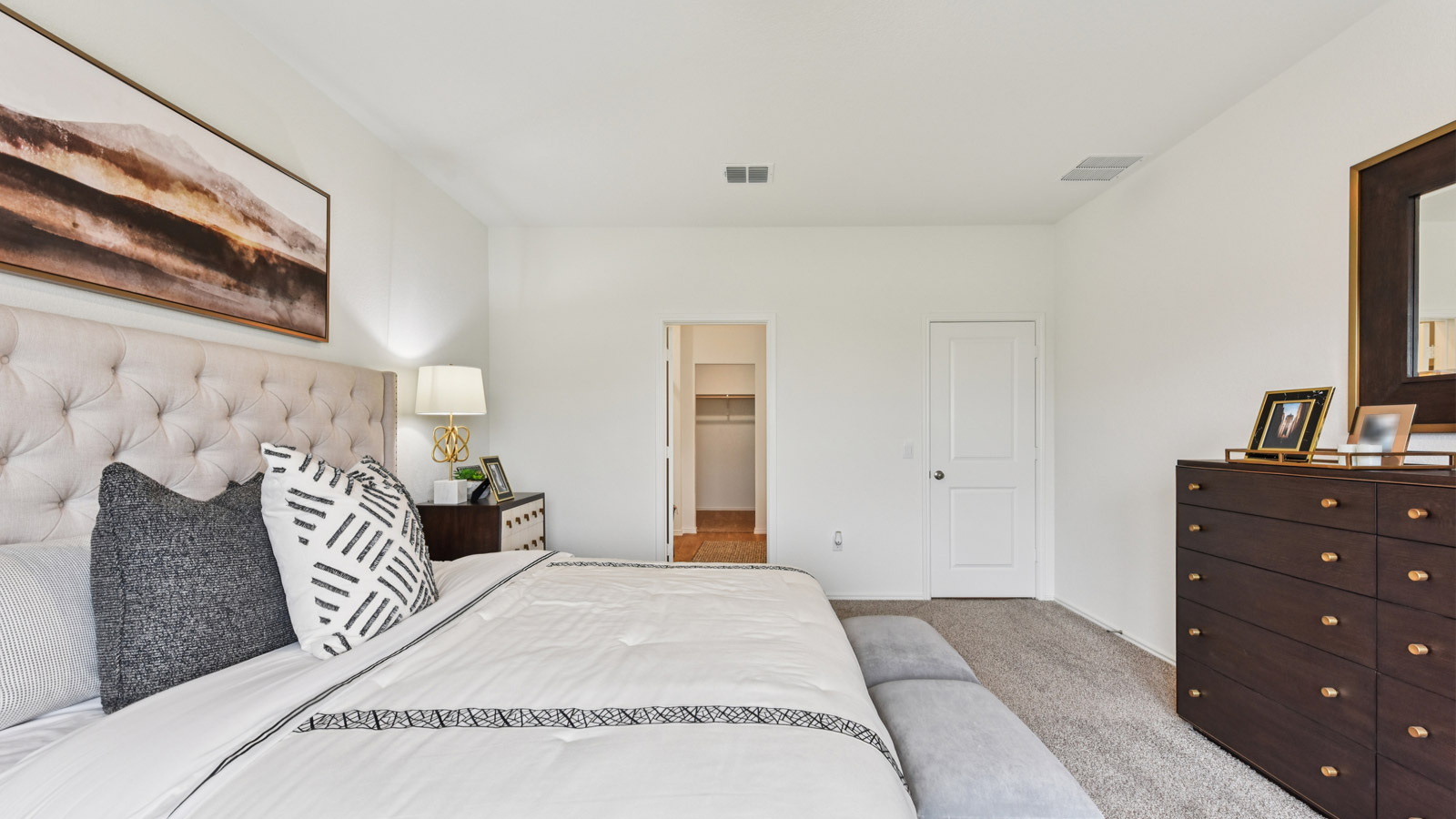Main bedroom with carpeted flooring and large windows.