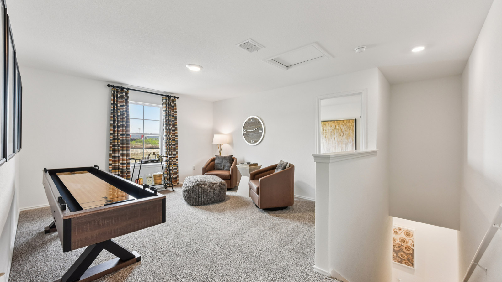 Upstairs game room with carpeted flooring.