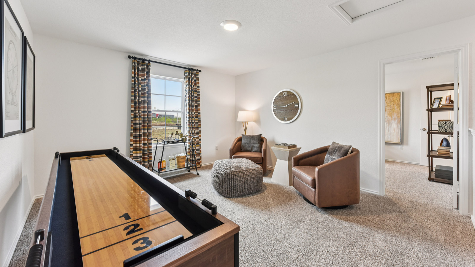 Upstairs game room with carpeted flooring.