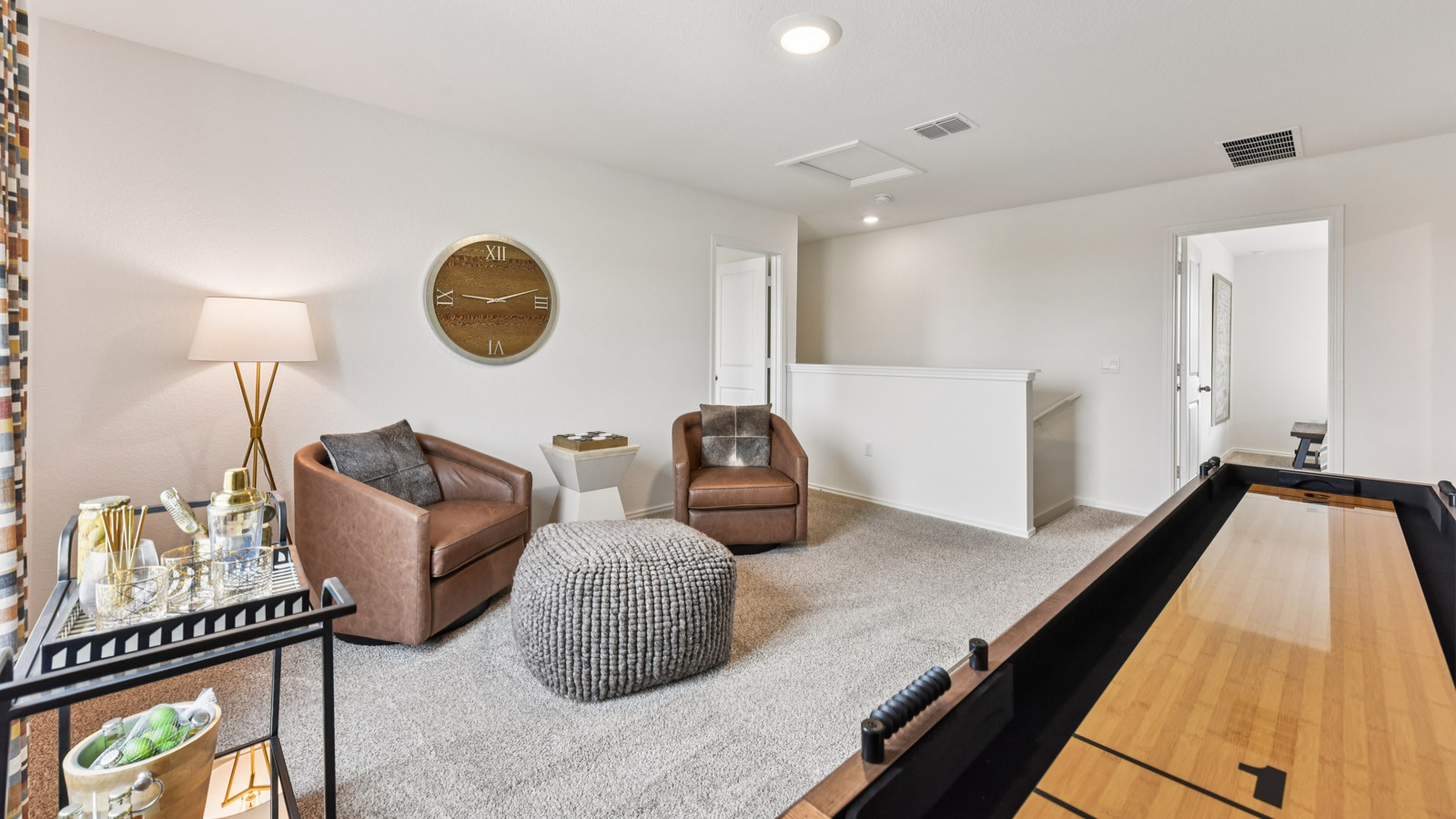 Upstairs game room with carpeted flooring.
