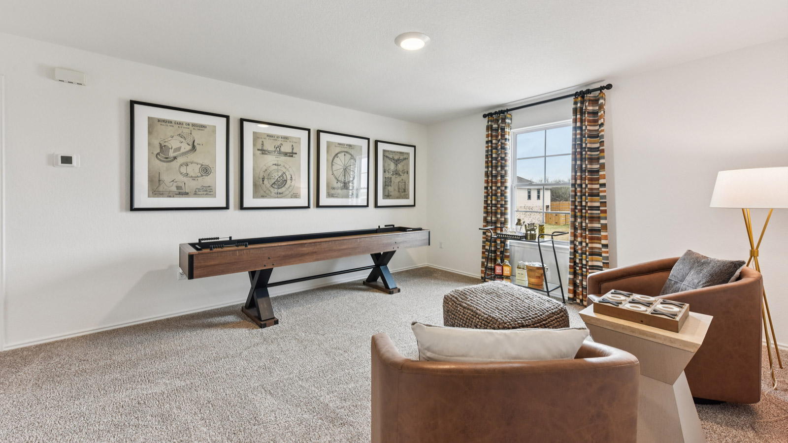 Upstairs game room with carpeted flooring.