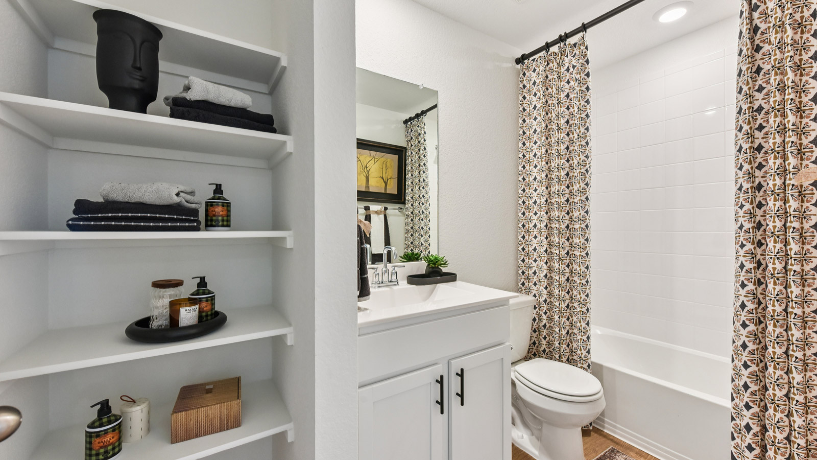 Bathroom 2 with tub and raised shower head.
