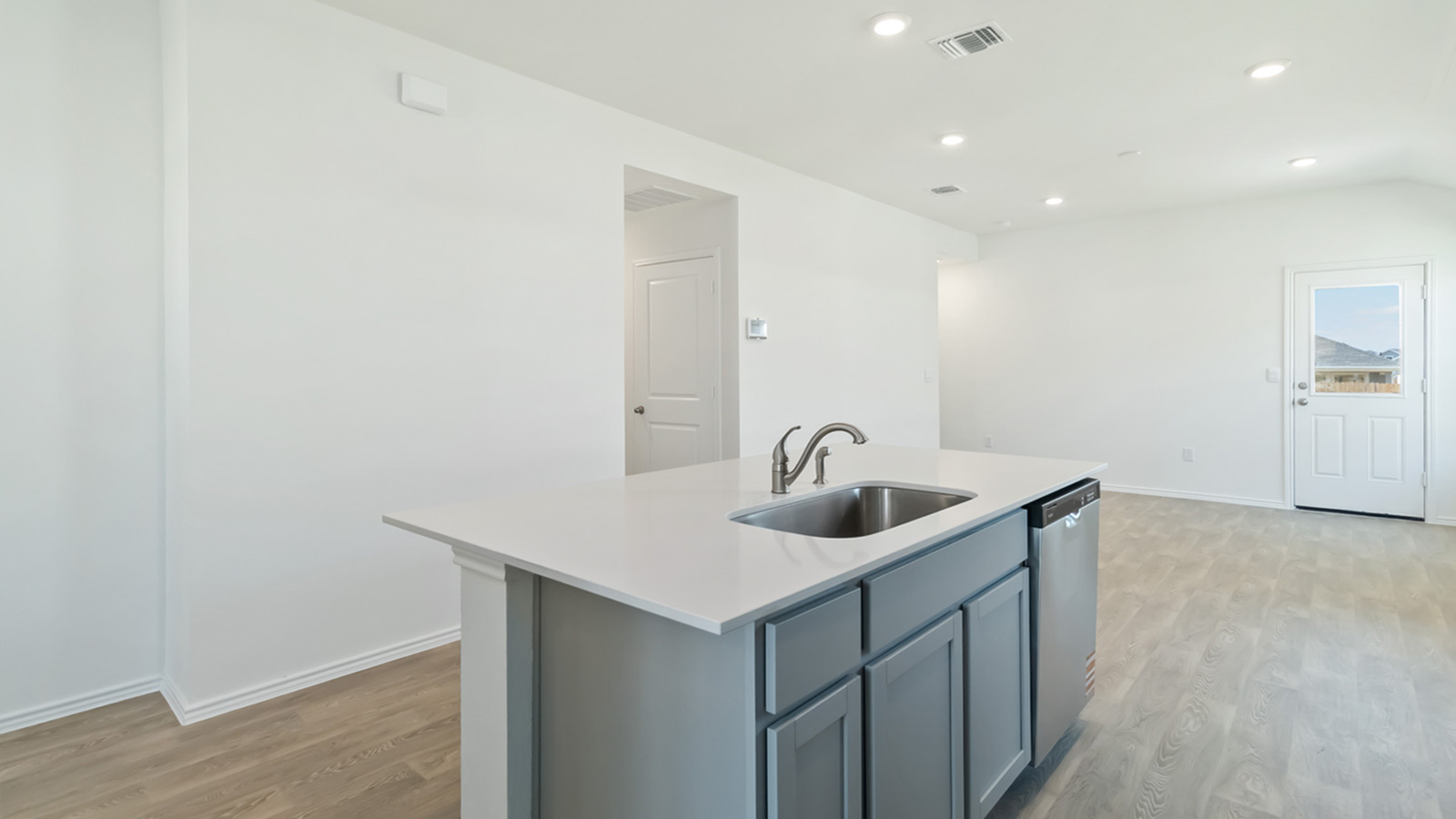 Kitchen with stainless steel appliances and quartz countertops.