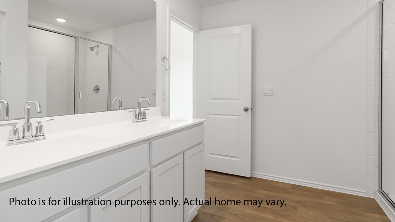 primary bathroom with double vanity and standing shower