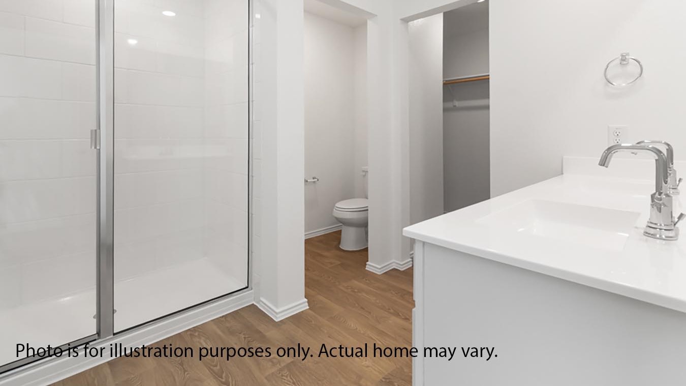 primary bathroom with double vanity and standing shower