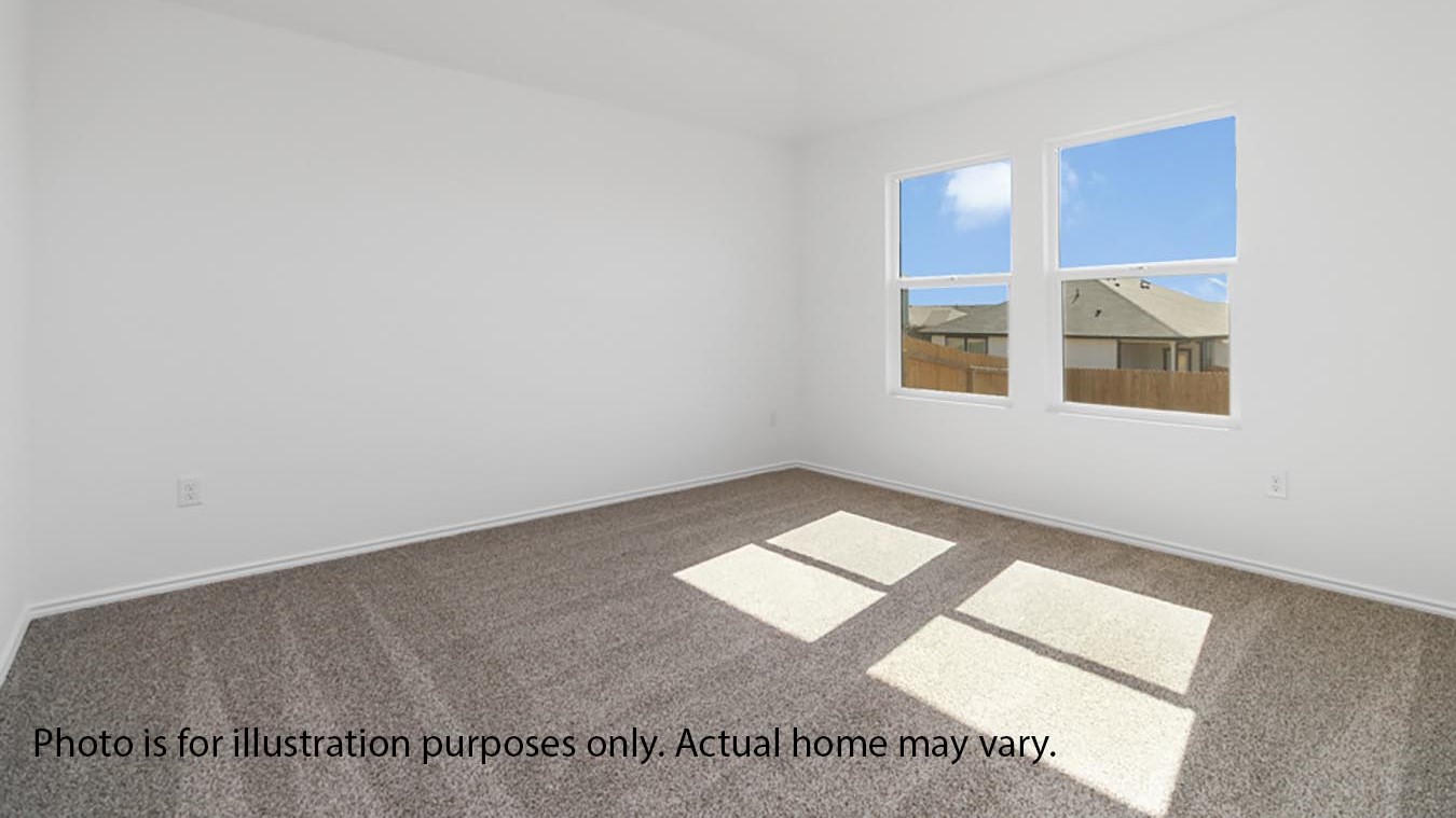 Primary bedroom with two windows and carpet