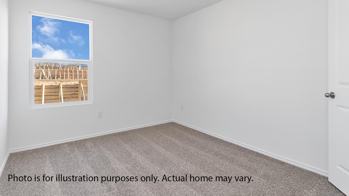 secondary bedroom with window and carpet