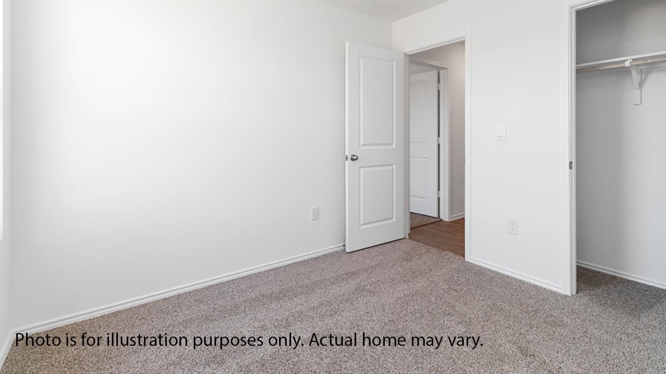 secondary bedroom with window and carpet