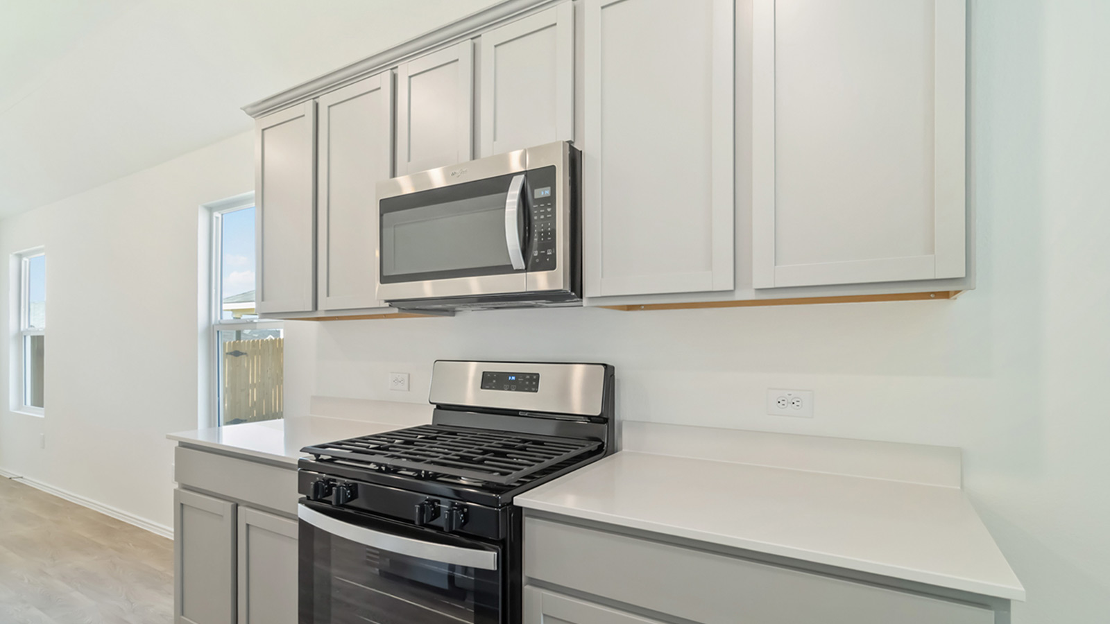 Kitchen with stainless steel appliances and quartz countertops.