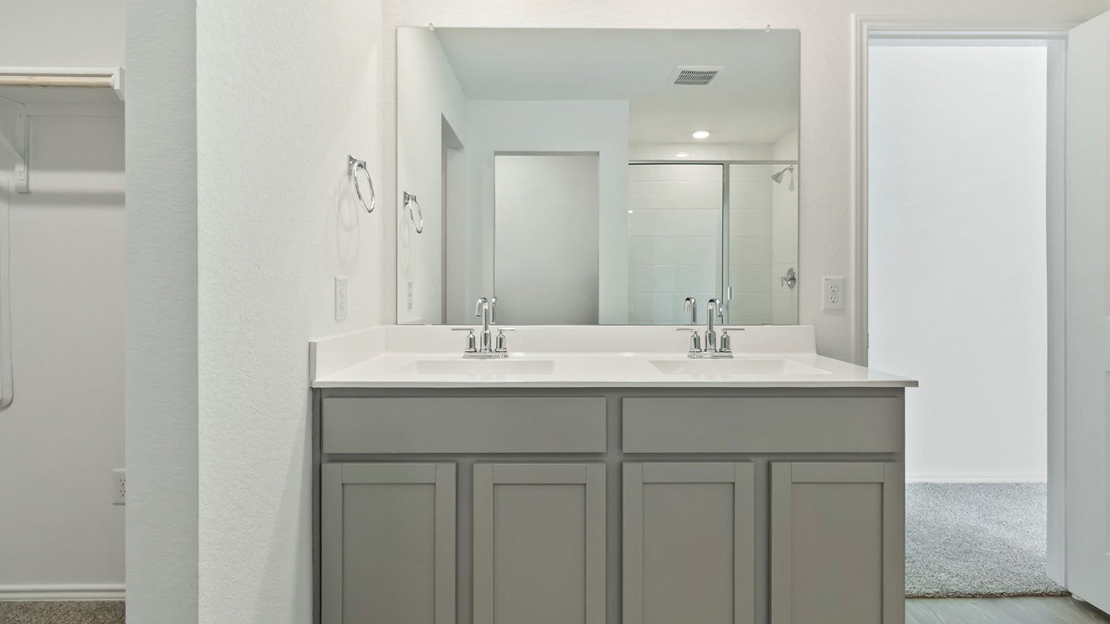 Luxurious main bathroom with double vanity sink and walk-in shower.