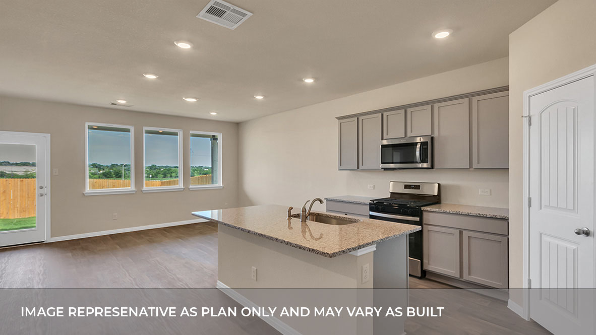 Interior kitchen with center island open to living area with windows