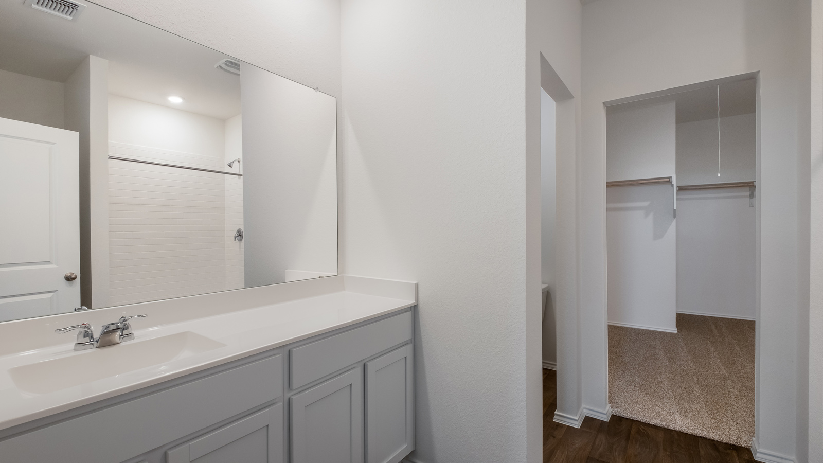 Interior bathroom with sink and walk-in closet