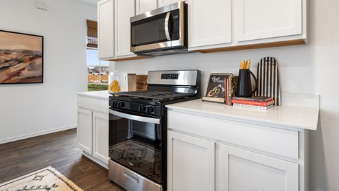 gourmet kitchen with quartz kitchen countertops and stainless steel appliances