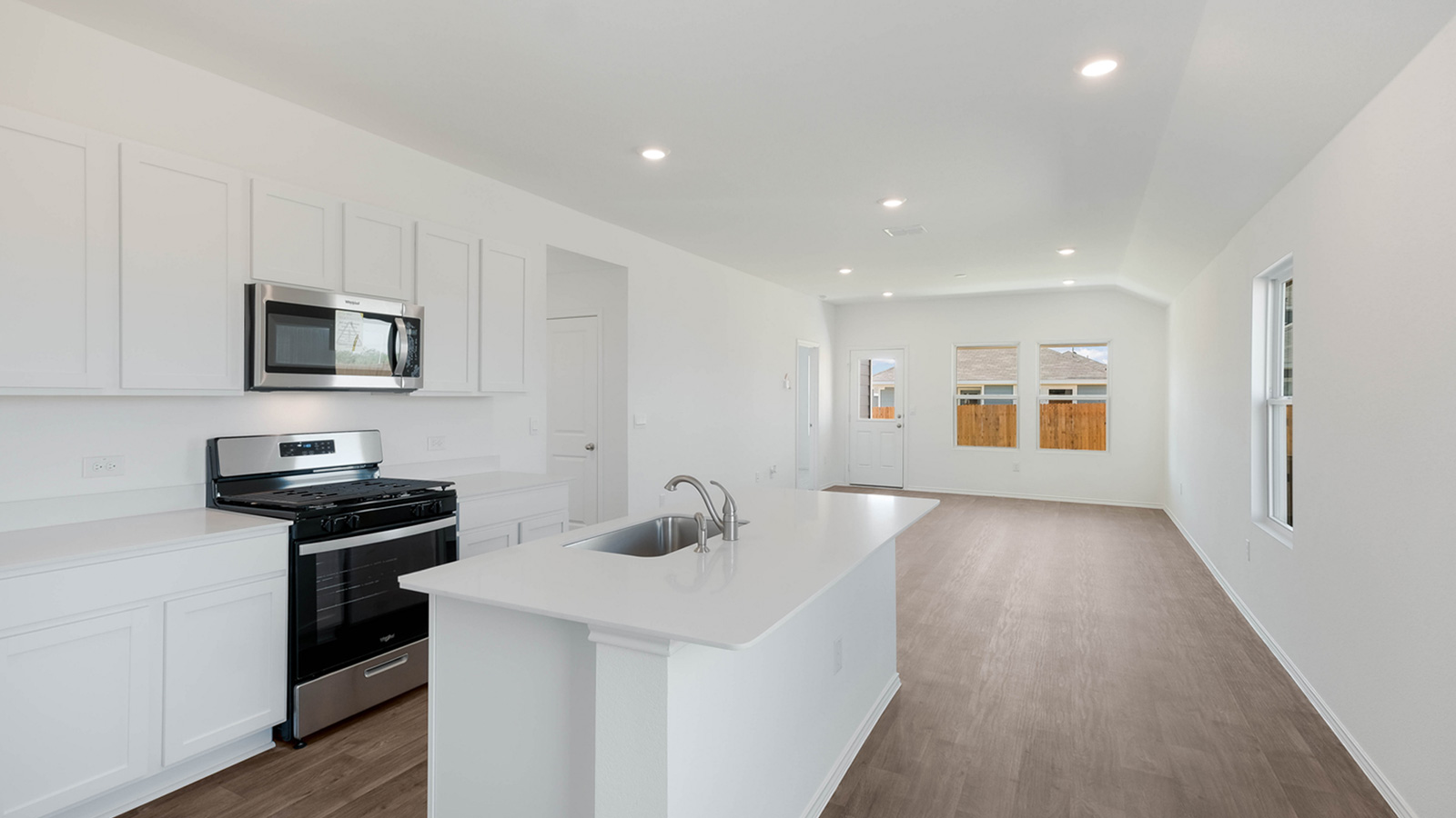 Kitchen with quartz countertops and stainless steel appliances.