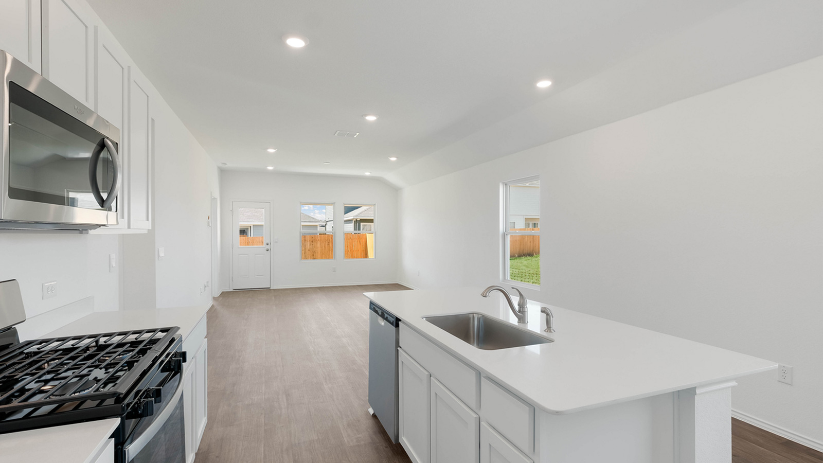 Kitchen with quartz countertops and stainless steel appliances.