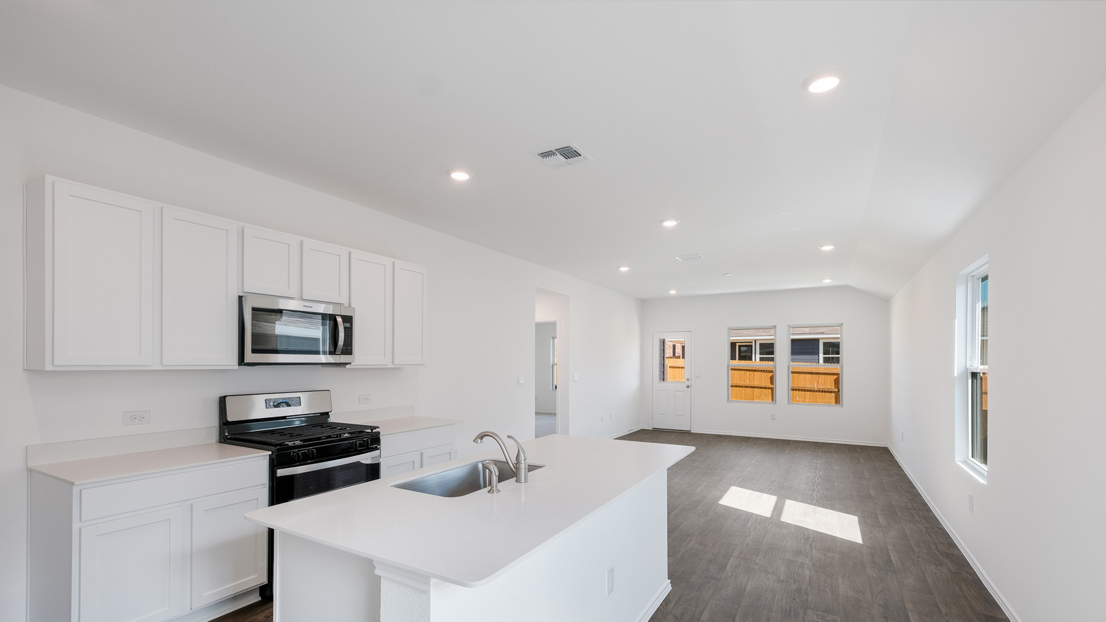 Kitchen with quartz countertops and stainless steel appliances.