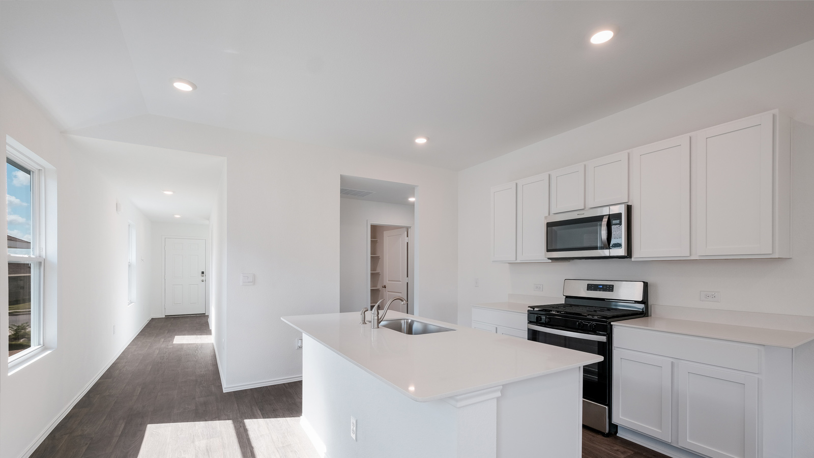 Kitchen with quartz countertops and stainless steel appliances.