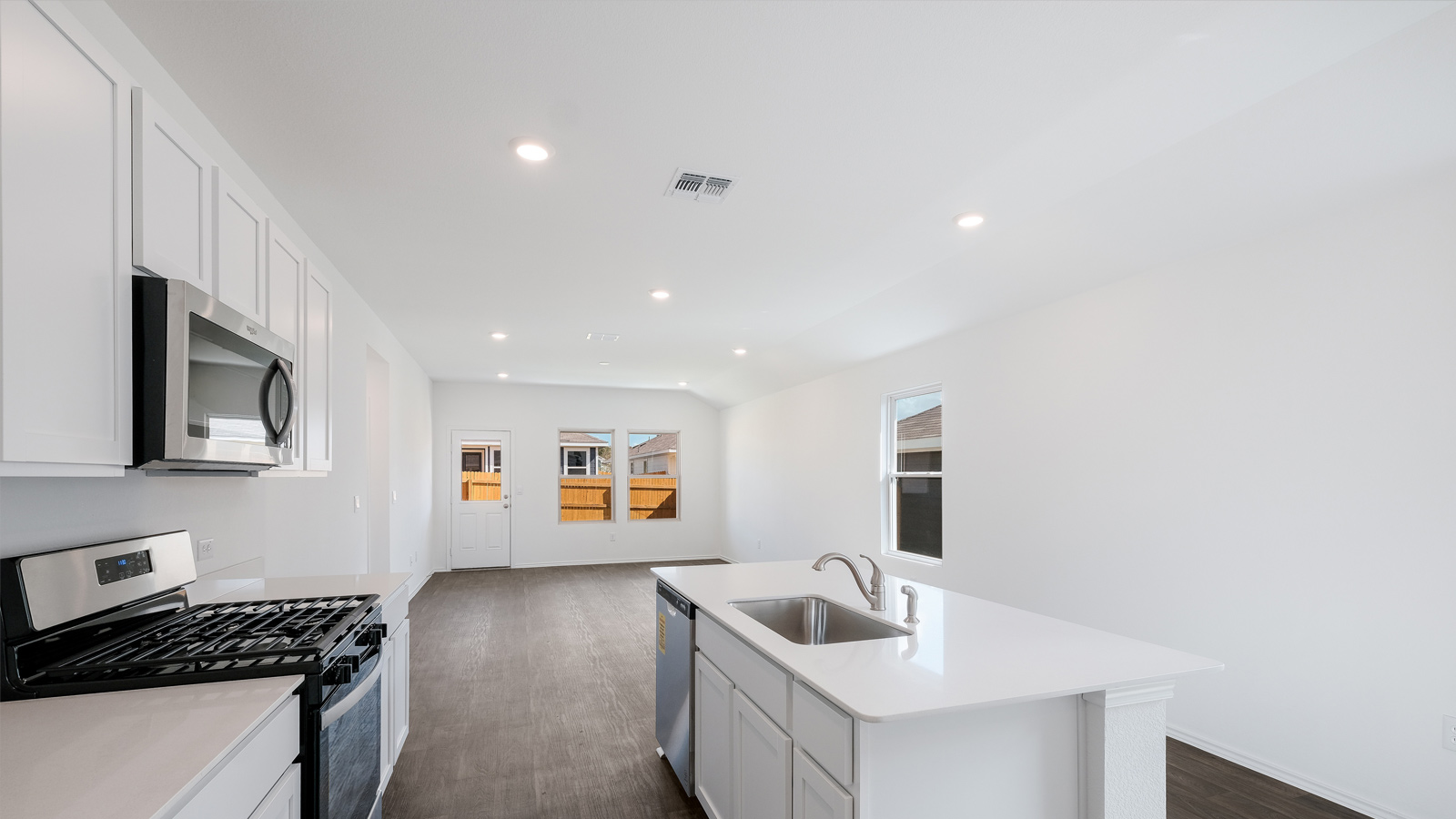 Kitchen with quartz countertops and stainless steel appliances.