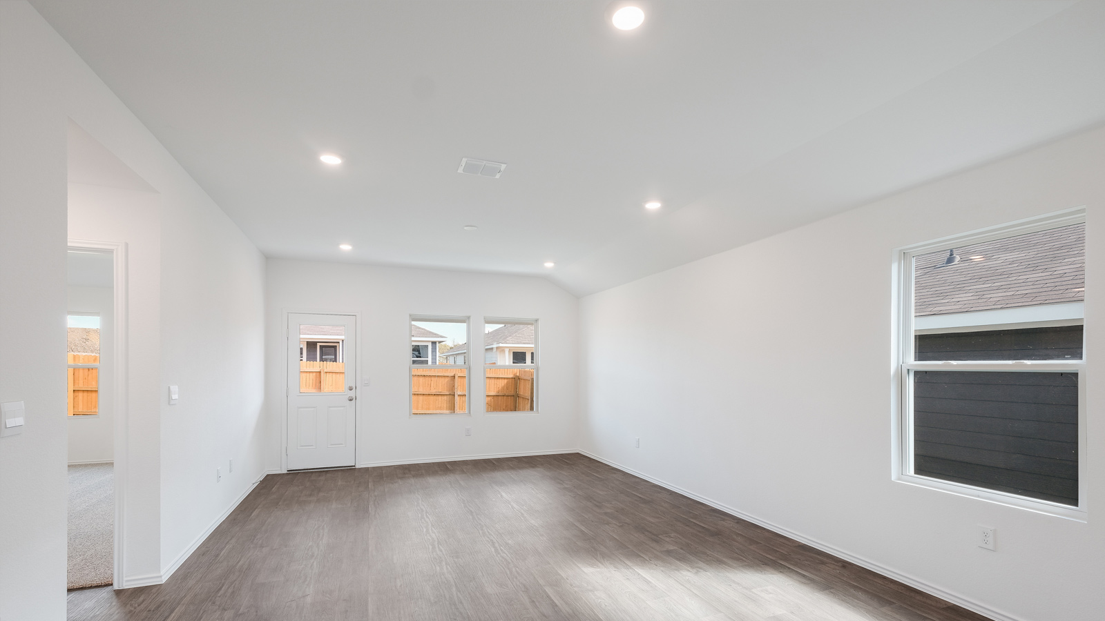 Open concept living room with windows.