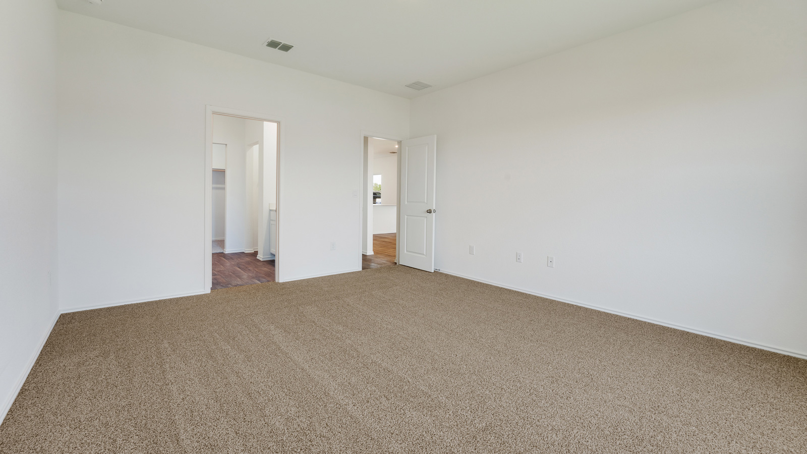 Main bedroom with carpeted floors.