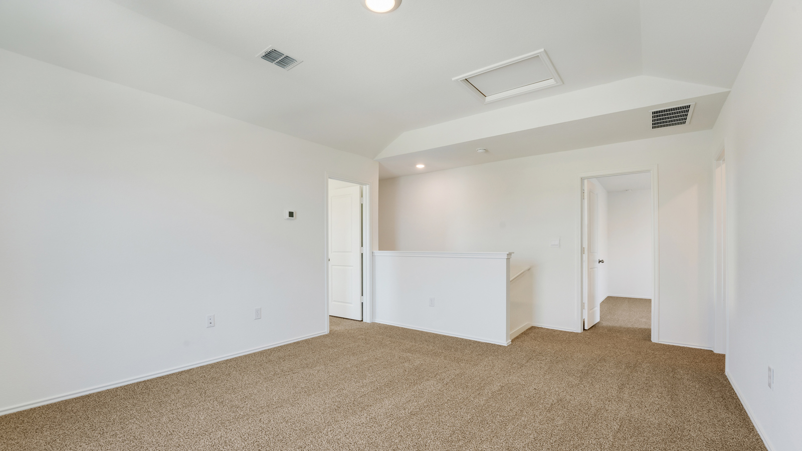 Upstairs gameroom with carpeted floors.