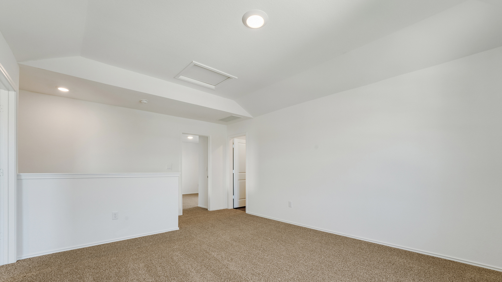 Upstairs gameroom with carpeted floors.