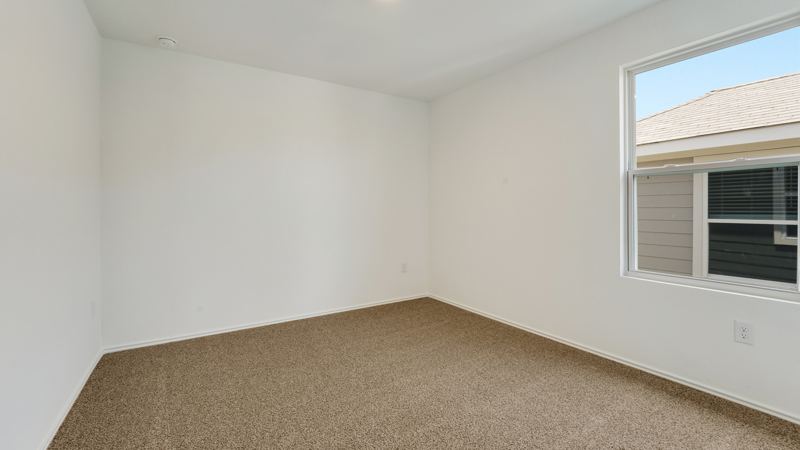 Bedroom 3 with carpeted floors and closet.