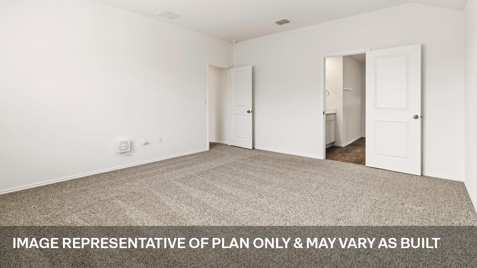 Primary bedroom with carpeted flooring.