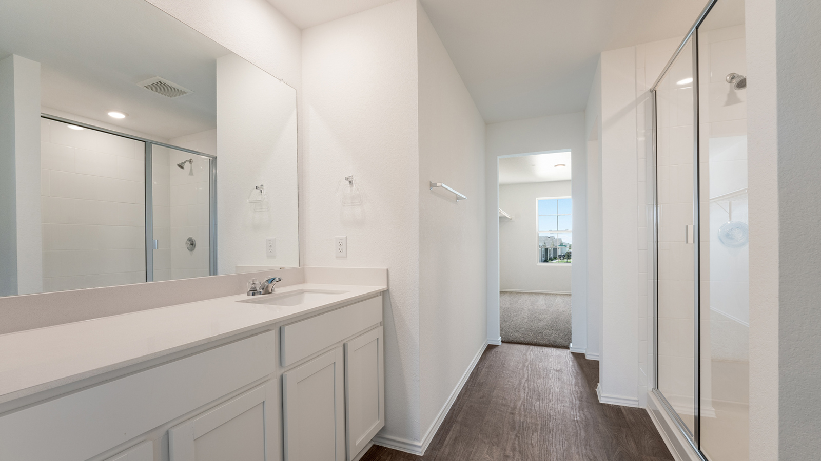 Modern main bathroom with single vanity sink and walk-in shower.