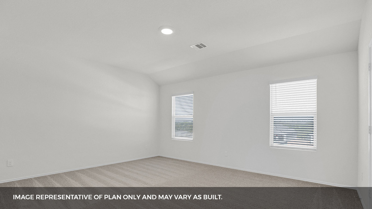 Primary bedroom with two windows.