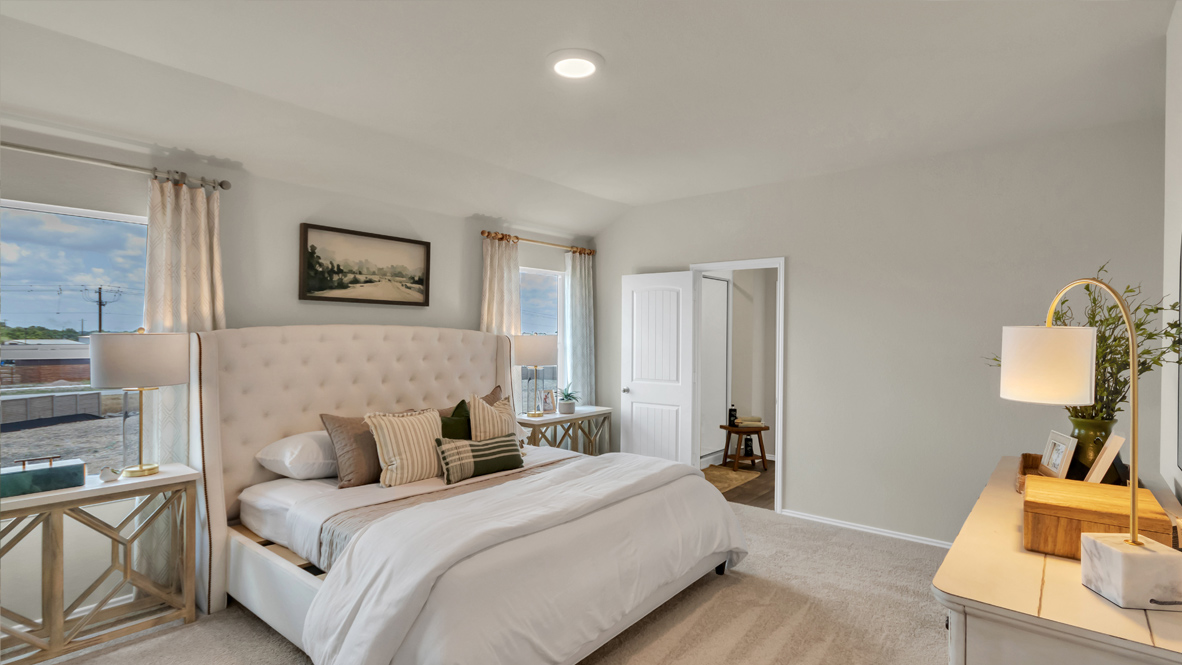 Spacious main bedroom with two windows.